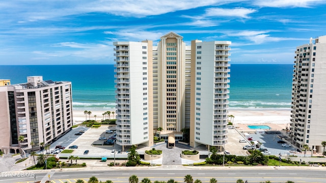 view of property featuring a beach view and a water view