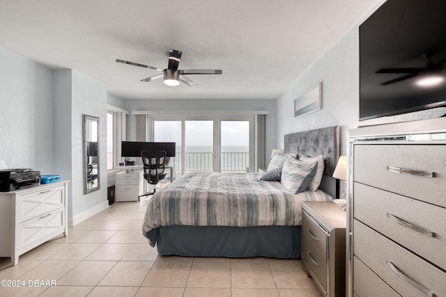 bedroom featuring ceiling fan, light tile patterned floors, and access to outside