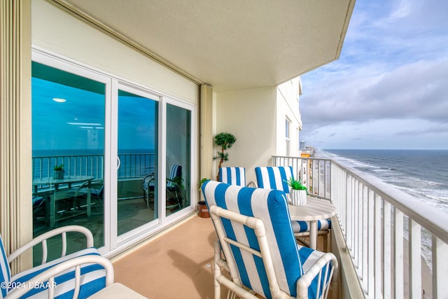 balcony with a beach view and a water view