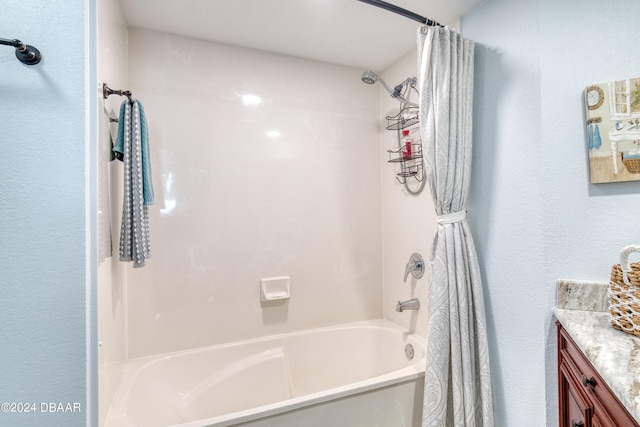 bathroom featuring vanity and shower / bath combination with curtain