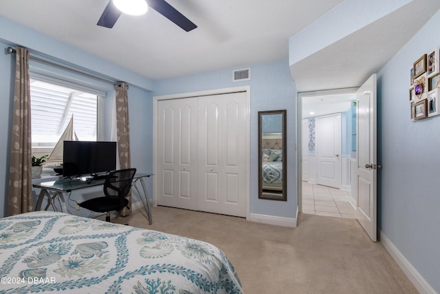 carpeted bedroom with a closet and ceiling fan