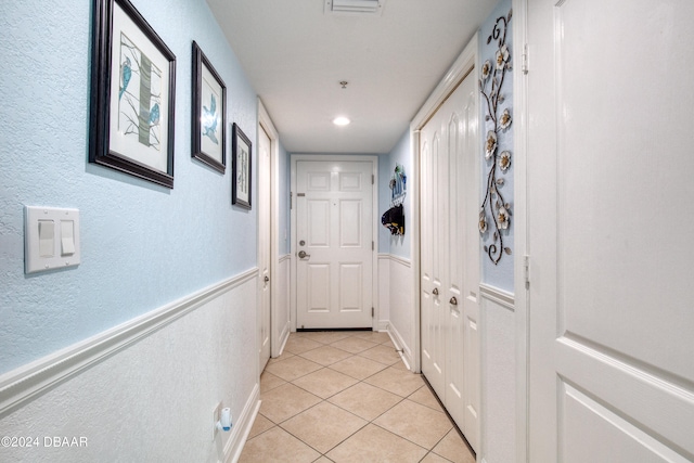 doorway with light tile patterned floors