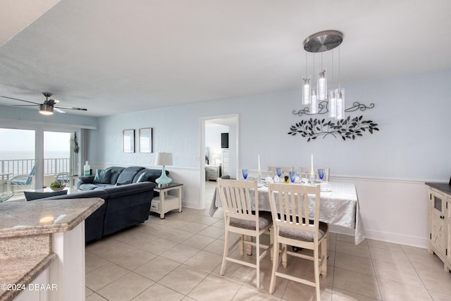 2937 S Atlantic Ave Unit 1504, Daytona Beach Shores, FL 32118 - dining room with light tile patterned flooring, a ceiling fan, baseboards, and a chandelier