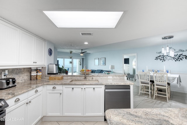 2937 S Atlantic Ave Unit 1504, Daytona Beach Shores, FL 32118 - kitchen with a peninsula, open floor plan, a ceiling fan, white cabinets, and light stone countertops