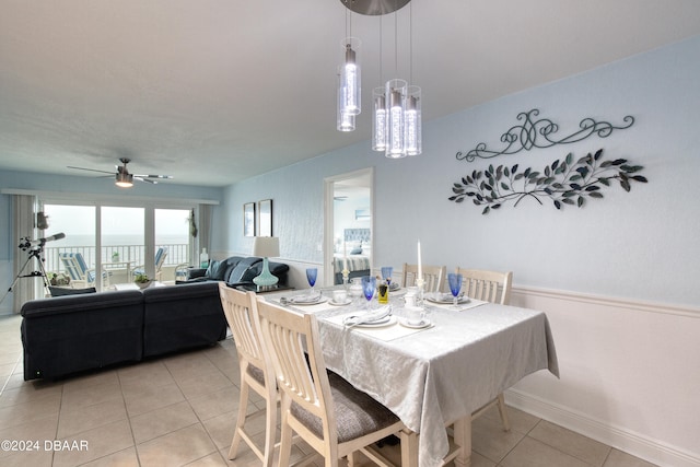 tiled dining room featuring ceiling fan