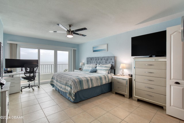 tiled bedroom featuring a textured ceiling and ceiling fan