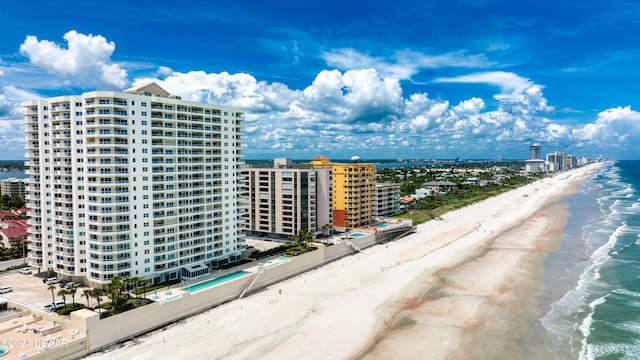 drone / aerial view featuring a beach view and a water view