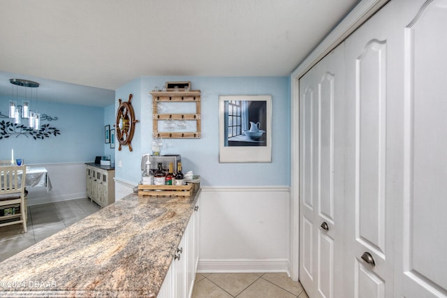 2937 S Atlantic Ave Unit 1504, Daytona Beach Shores, FL 32118 - bar area featuring light tile patterned floors, baseboards, and pendant lighting