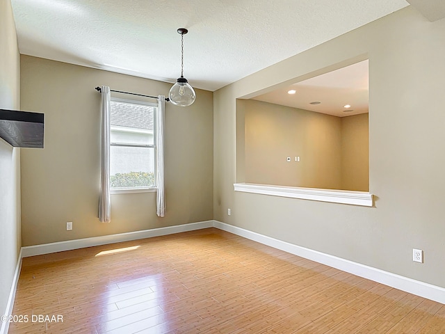 417 Grande Sunningdale Loop, Daytona Beach, FL 32124 - empty room featuring hardwood / wood-style floors, baseboards, a textured ceiling, and recessed lighting