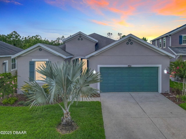 417 Grande Sunningdale Loop, Daytona Beach, FL 32124 - view of front facade featuring stucco siding, a garage, and a yard