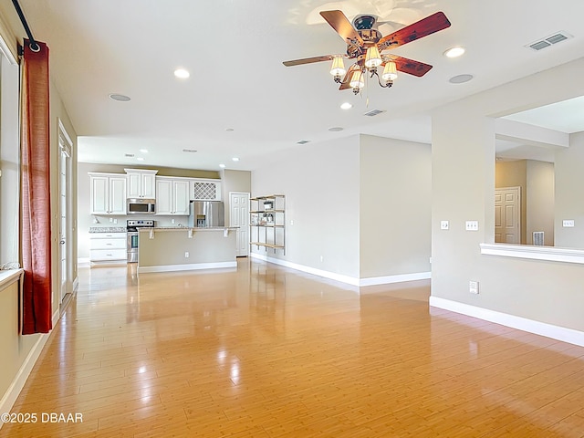 417 Grande Sunningdale Loop, Daytona Beach, FL 32124 - unfurnished living room featuring ceiling fan, light wood-style flooring, recessed lighting, and baseboards