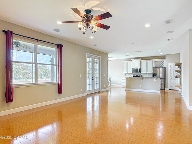 417 Grande Sunningdale Loop, Daytona Beach, FL 32124 - unfurnished living room featuring a ceiling fan, light wood finished floors, baseboards, and recessed lighting