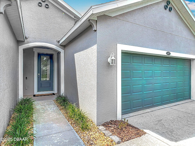 417 Grande Sunningdale Loop, Daytona Beach, FL 32124 - entrance to property featuring stucco siding and a garage