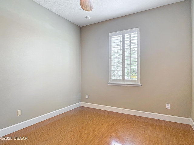 417 Grande Sunningdale Loop, Daytona Beach, FL 32124 - unfurnished room with light wood finished floors, baseboards, a ceiling fan, and a smoke detector