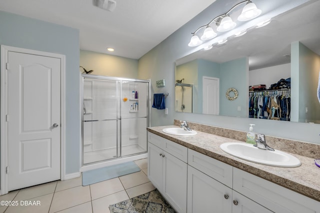 448 White Coral Ln, New Smyrna Beach, FL 32168 - bathroom with tile patterned floors, a shower stall, double vanity, and a spacious closet