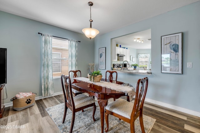 448 White Coral Ln, New Smyrna Beach, FL 32168 - dining space with wood finished floors and baseboards
