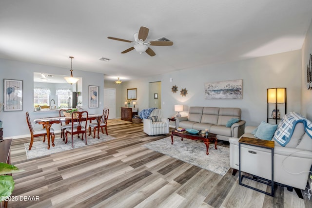 448 White Coral Ln, New Smyrna Beach, FL 32168 - living area with wood finished floors and ceiling fan