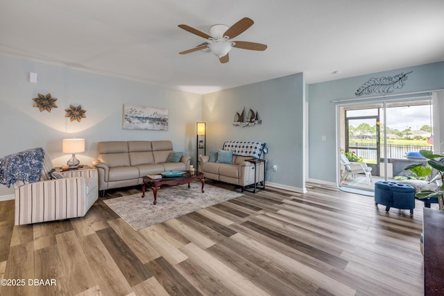 448 White Coral Ln, New Smyrna Beach, FL 32168 - living area with wood finished floors, a ceiling fan, and a water view