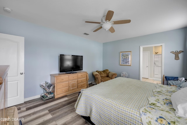 448 White Coral Ln, New Smyrna Beach, FL 32168 - bedroom with light wood-style floors, a ceiling fan, and ensuite bathroom