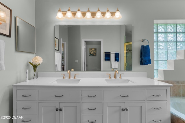 full bath with double vanity, a sink, and a bath