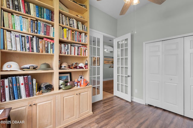 living area with dark wood-style floors, baseboards, a ceiling fan, and french doors