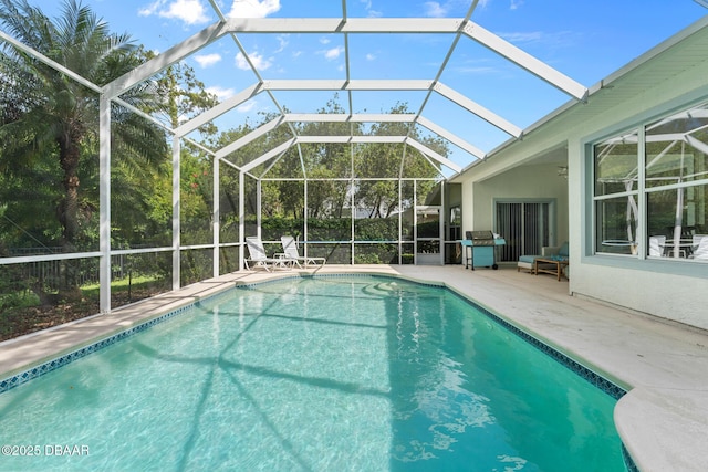 pool featuring a lanai and a patio area