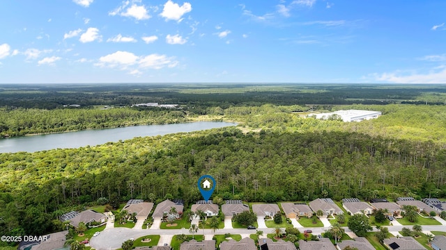 birds eye view of property featuring a forest view, a water view, and a residential view