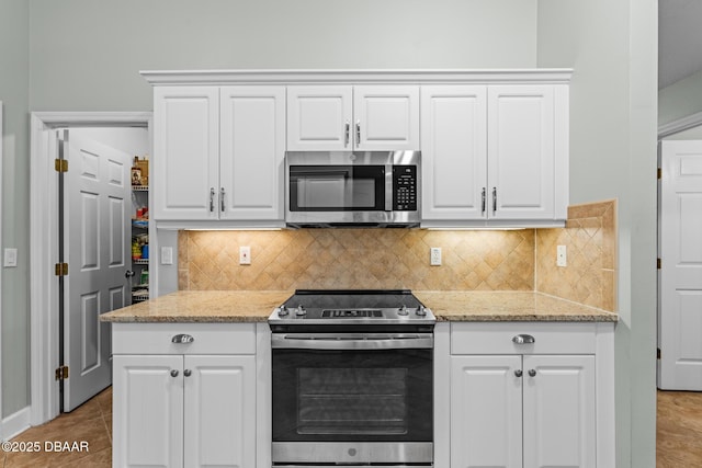 kitchen with appliances with stainless steel finishes and white cabinets