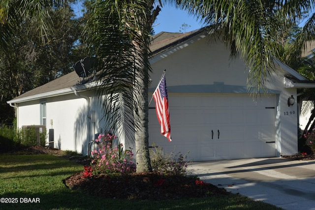 view of property exterior with concrete driveway, an attached garage, and stucco siding