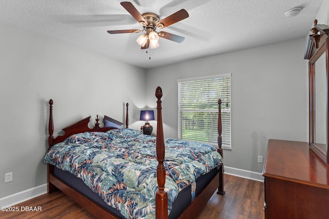 bedroom featuring a textured ceiling, baseboards, and dark wood-type flooring