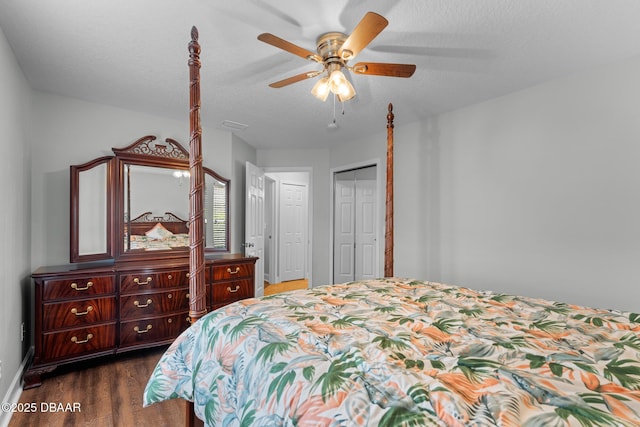 bedroom featuring dark wood-style floors, ceiling fan, a textured ceiling, and baseboards