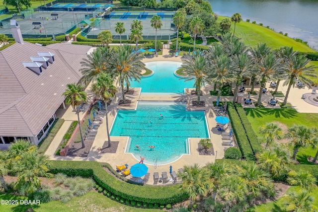 pool with a water view and a patio area