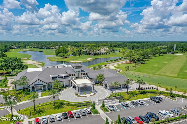 birds eye view of property featuring view of golf course and a water view