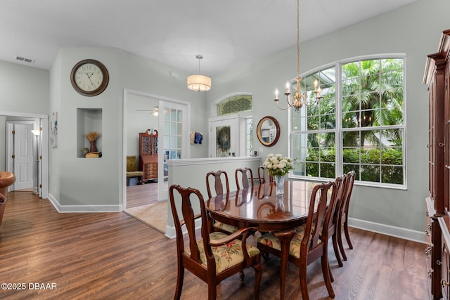 dining space with dark wood-style floors, visible vents, and plenty of natural light