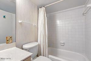 4175 S Atlantic Ave Unit 405, New Smyrna Beach, FL 32169 - full bathroom with toilet, shower / bathtub combination with curtain, and vanity