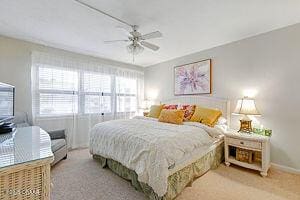 4175 S Atlantic Ave Unit 405, New Smyrna Beach, FL 32169 - bedroom with carpet flooring, a ceiling fan, and baseboards