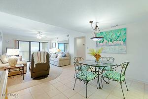 4175 S Atlantic Ave Unit 405, New Smyrna Beach, FL 32169 - tiled dining area featuring a ceiling fan