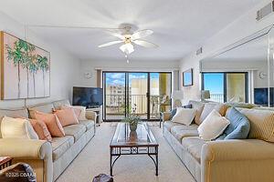 4175 S Atlantic Ave Unit 405, New Smyrna Beach, FL 32169 - living area featuring plenty of natural light and ceiling fan