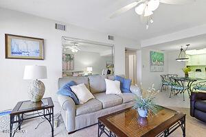 4175 S Atlantic Ave Unit 405, New Smyrna Beach, FL 32169 - carpeted living area featuring ceiling fan