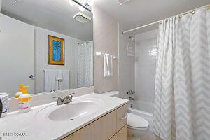 4175 S Atlantic Ave Unit 405, New Smyrna Beach, FL 32169 - bathroom with toilet, vanity, and shower / bath combo