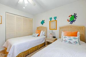 4175 S Atlantic Ave Unit 405, New Smyrna Beach, FL 32169 - bedroom with ceiling fan and a closet