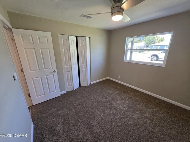 1909 Nelson Ave, Ormond Beach, FL 32174 - unfurnished bedroom with a closet, visible vents, baseboards, and dark colored carpet