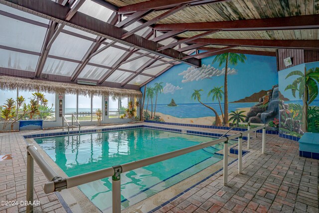 view of swimming pool with a patio area and a water view