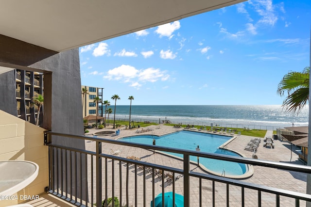 view of swimming pool with a view of the beach and a water view