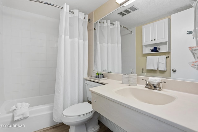 full bathroom with a textured ceiling, vanity, shower / bath combo with shower curtain, wood-type flooring, and toilet