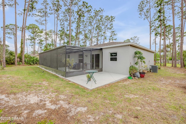 back of house with cooling unit, a patio area, a yard, a sunroom, and stucco siding