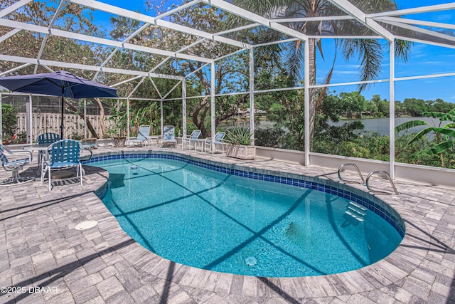 outdoor pool featuring a patio area and a lanai