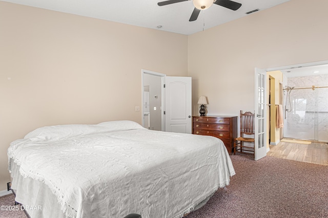 carpeted bedroom featuring visible vents, a high ceiling, and ceiling fan
