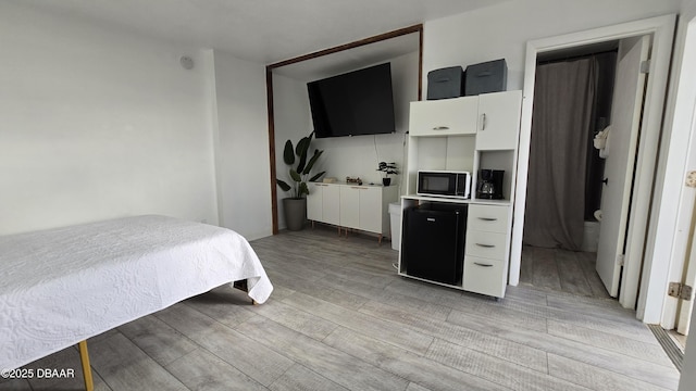 bedroom with light hardwood / wood-style floors