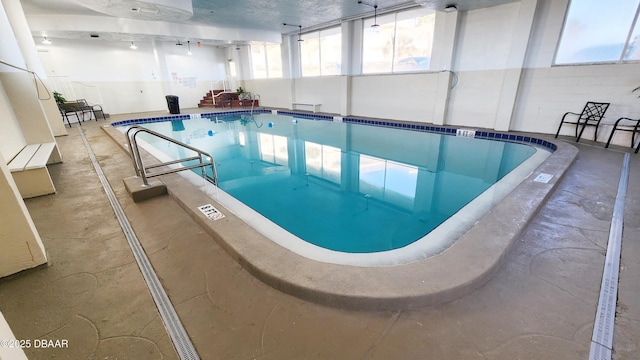 view of swimming pool with a hot tub